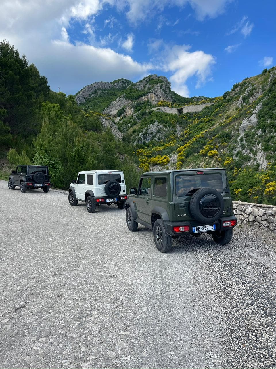 Three Suzuki Jimnys in convoy on an Albanian mountain road